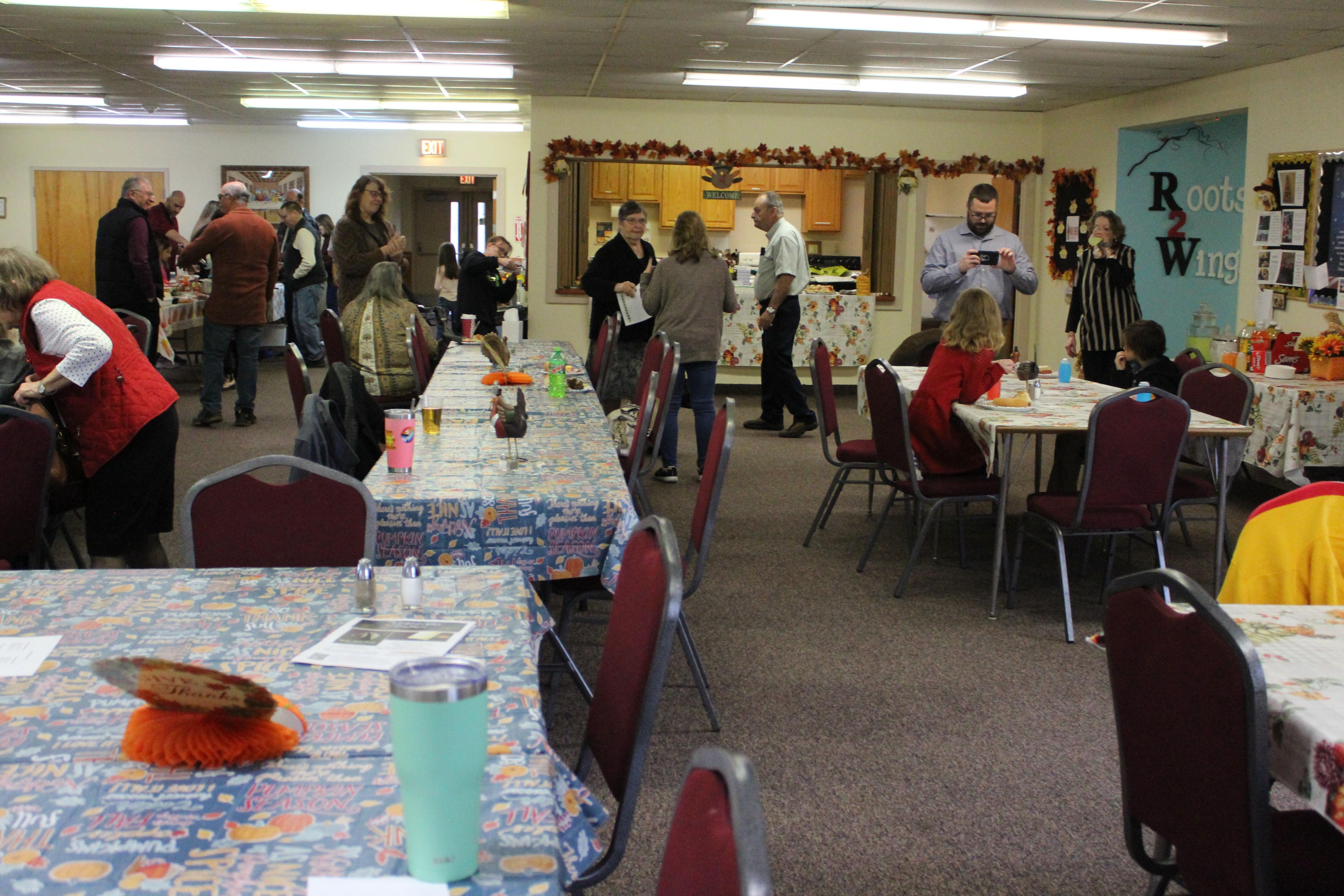 Families gathered around tables for a meal at Discovery Church